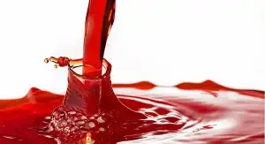 Conceptual image of red diesel fuel being poured